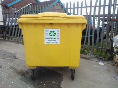 yellow recycling bin in focus